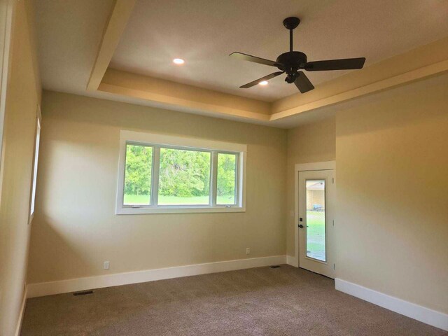 8800 86th Ave N, Greenfield, MN 55373 - carpeted empty room featuring a raised ceiling, a ceiling fan, and recessed lighting