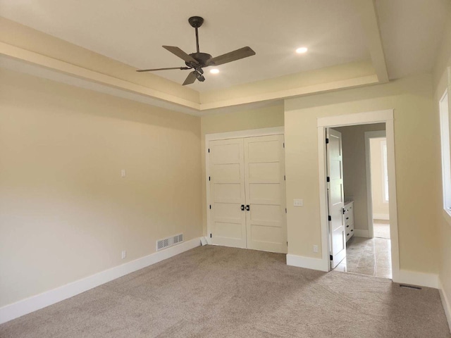 8800 86th Ave N, Greenfield, MN 55373 - unfurnished bedroom featuring a tray ceiling, carpet flooring, a closet, recessed lighting, and a ceiling fan