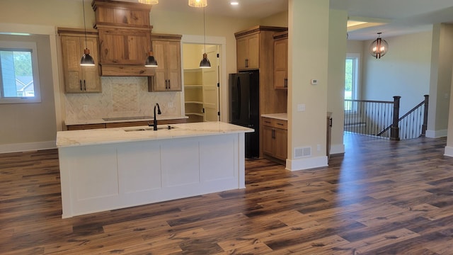 8800 86th Ave N, Greenfield, MN 55373 - kitchen with freestanding refrigerator, decorative backsplash, dark wood-style flooring, a center island with sink, and decorative light fixtures