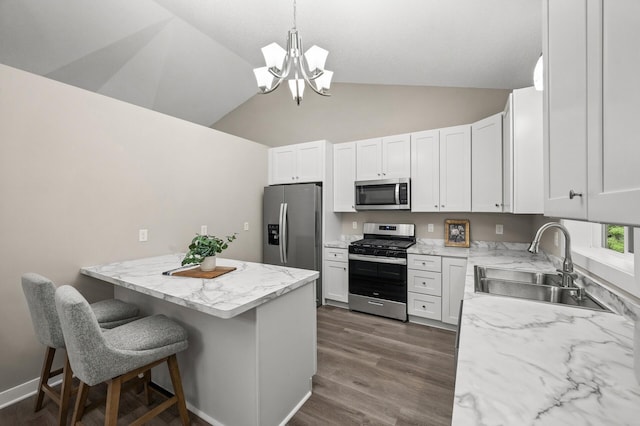 3825 122nd Ave NW, Coon Rapids, MN 55433 - kitchen with stainless steel appliances, a sink, a chandelier, a breakfast bar area, and white cabinets