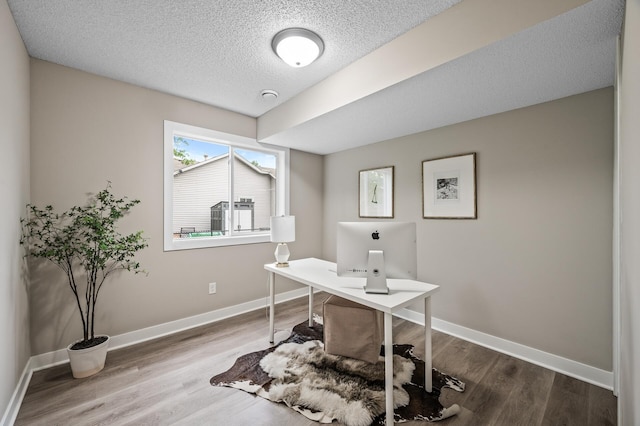 3825 122nd Ave NW, Coon Rapids, MN 55433 - home office featuring wood finished floors, a textured ceiling, and baseboards