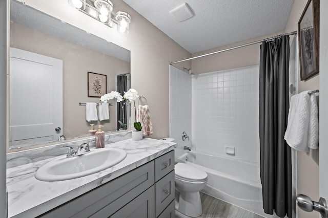 3825 122nd Ave NW, Coon Rapids, MN 55433 - full bath featuring vanity, shower / tub combo with curtain, toilet, a textured ceiling, and wood finished floors