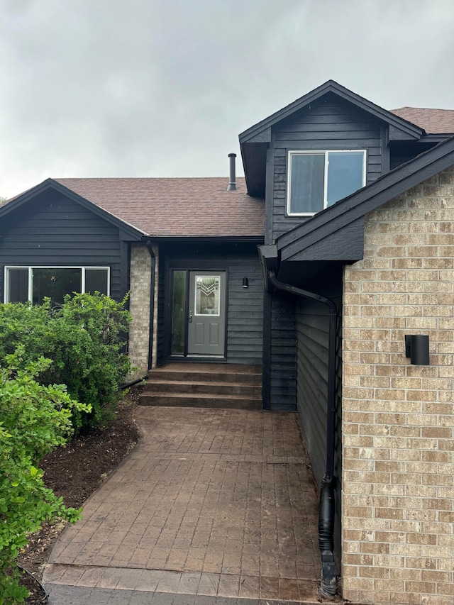 3825 122nd Ave NW, Coon Rapids, MN 55433 - view of front of home featuring brick siding and roof with shingles