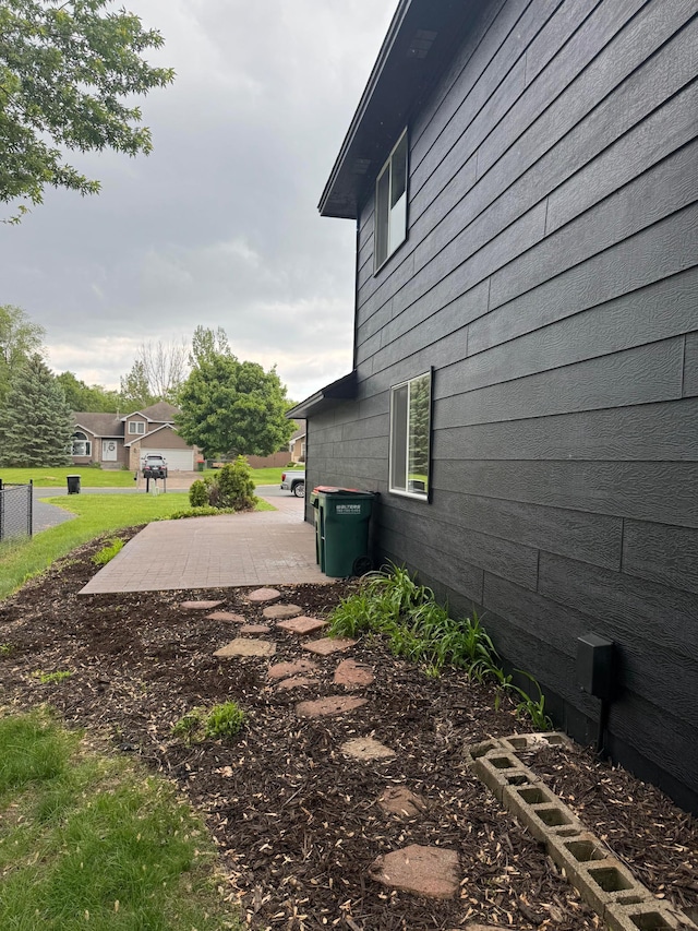 3825 122nd Ave NW, Coon Rapids, MN 55433 - view of side of home with a patio area