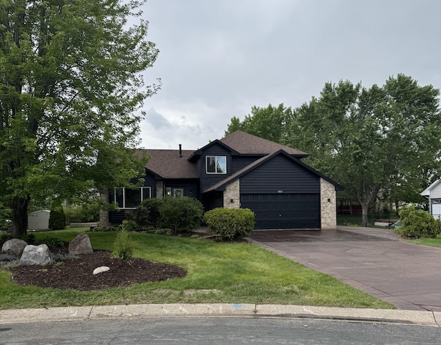 3825 122nd Ave NW, Coon Rapids, MN 55433 - tri-level home featuring asphalt driveway, a garage, a front yard, brick siding, and a shingled roof