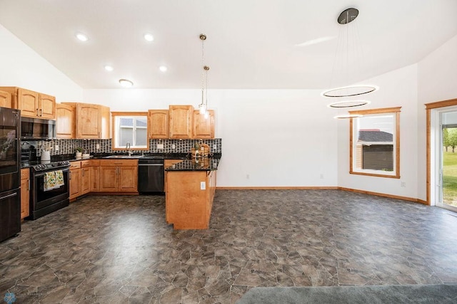 7214 Eagle Pointe Dr S, Fargo, ND 58104 - kitchen featuring black appliances, a sink, stone finish flooring, dark countertops, and vaulted ceiling