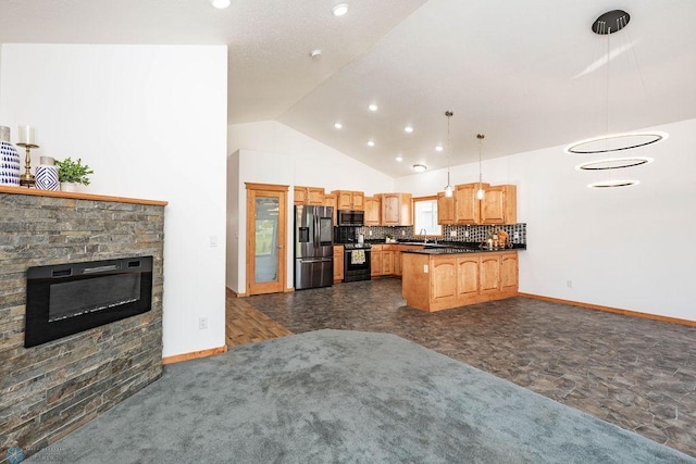 7214 Eagle Pointe Dr S, Fargo, ND 58104 - kitchen with appliances with stainless steel finishes, dark countertops, a peninsula, open floor plan, and a stone fireplace