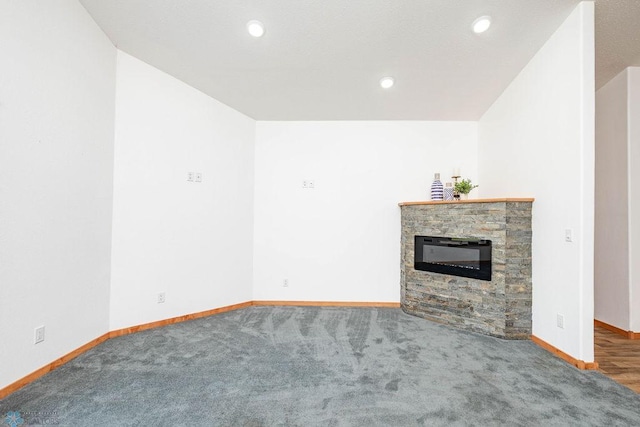 7214 Eagle Pointe Dr S, Fargo, ND 58104 - unfurnished living room with carpet flooring, baseboards, a stone fireplace, and recessed lighting