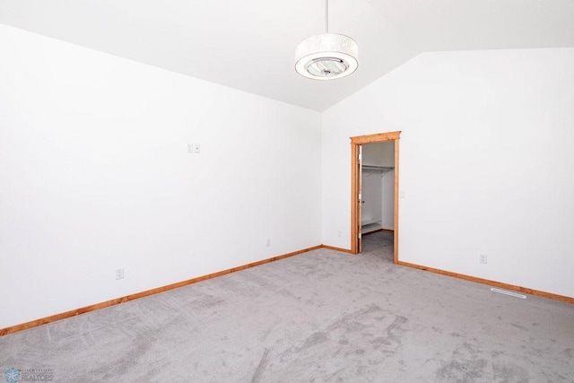 7214 Eagle Pointe Dr S, Fargo, ND 58104 - unfurnished bedroom featuring carpet, lofted ceiling, baseboards, and a spacious closet