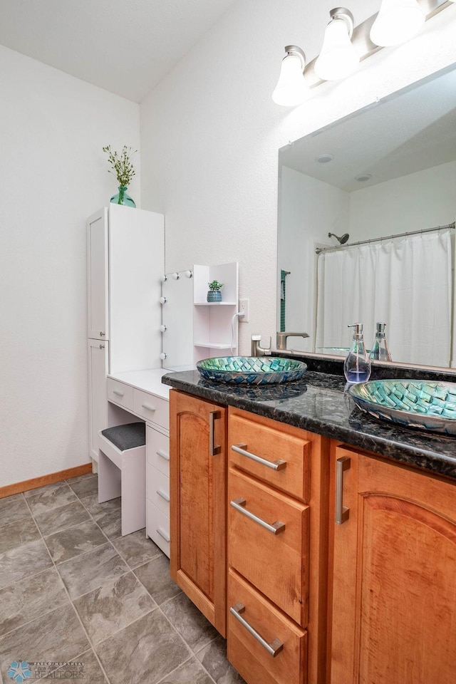 7214 Eagle Pointe Dr S, Fargo, ND 58104 - bathroom with vanity, baseboards, and a shower with shower curtain