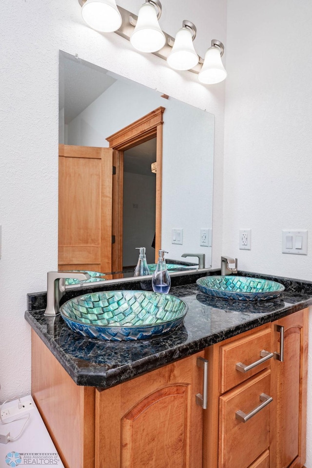 7214 Eagle Pointe Dr S, Fargo, ND 58104 - bathroom featuring double vanity and a textured wall