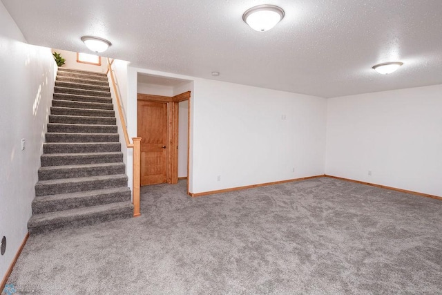 7214 Eagle Pointe Dr S, Fargo, ND 58104 - finished basement featuring a textured ceiling, stairway, carpet flooring, and baseboards