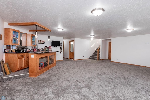 7214 Eagle Pointe Dr S, Fargo, ND 58104 - kitchen featuring a textured ceiling, open floor plan, dark countertops, carpet floors, and baseboards