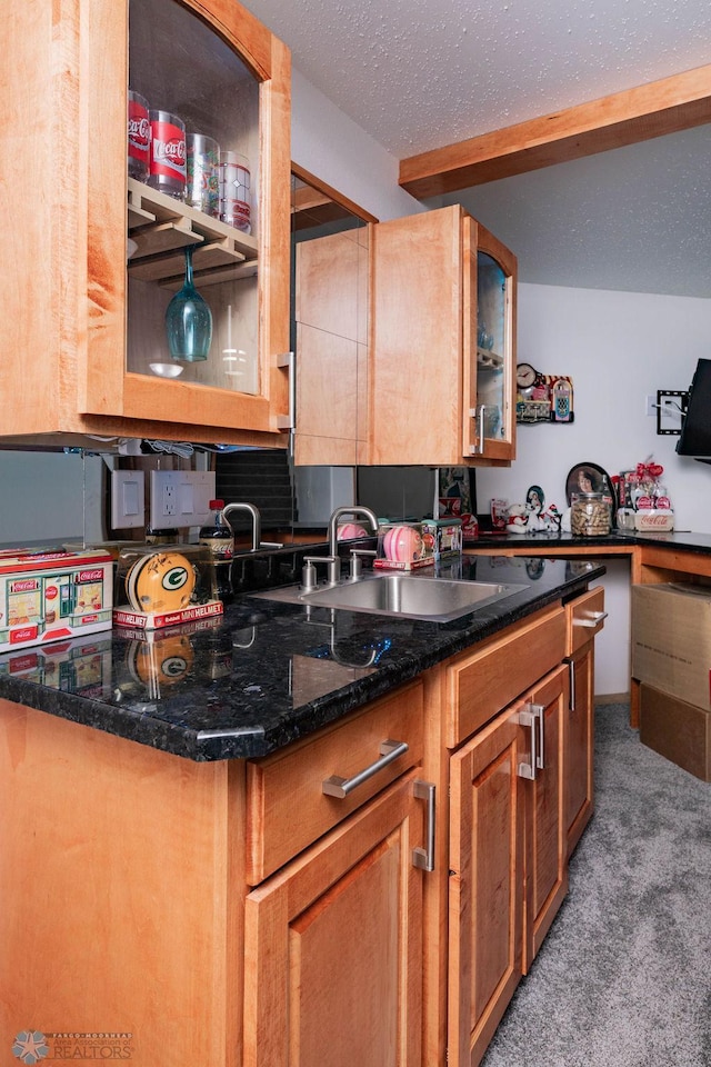 7214 Eagle Pointe Dr S, Fargo, ND 58104 - kitchen featuring light carpet, glass insert cabinets, beam ceiling, brown cabinetry, and a sink