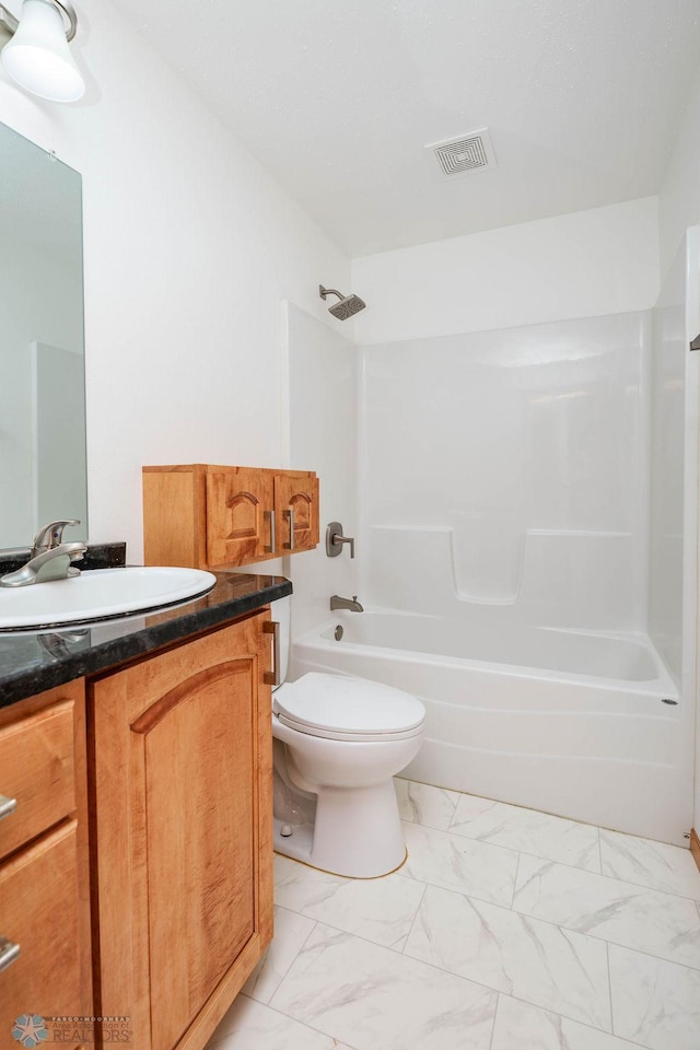 7214 Eagle Pointe Dr S, Fargo, ND 58104 - bathroom featuring marble finish flooring, vanity,  shower combination, and toilet