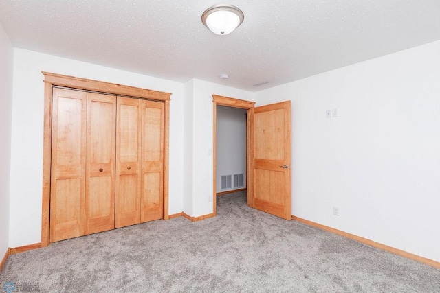 7214 Eagle Pointe Dr S, Fargo, ND 58104 - unfurnished bedroom featuring carpet, baseboards, a textured ceiling, and a closet