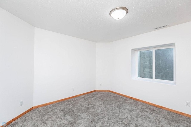 7214 Eagle Pointe Dr S, Fargo, ND 58104 - carpeted spare room with baseboards and a textured ceiling