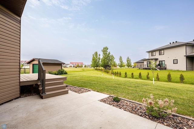 7214 Eagle Pointe Dr S, Fargo, ND 58104 - view of grassy yard featuring a deck and a patio area