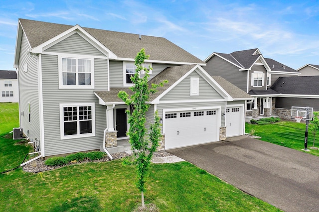 9842 51st St NE, Saint Michael, MN 55376 - view of front of property with asphalt driveway, central AC, stone siding, and a front yard