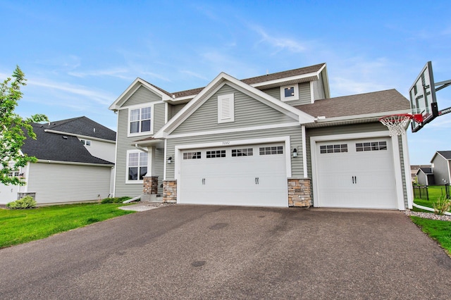 9842 51st St NE, Saint Michael, MN 55376 - view of front of house featuring stone siding, asphalt driveway, a garage, and roof with shingles