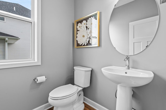 9842 51st St NE, Saint Michael, MN 55376 - bathroom featuring baseboards, toilet, and wood finished floors