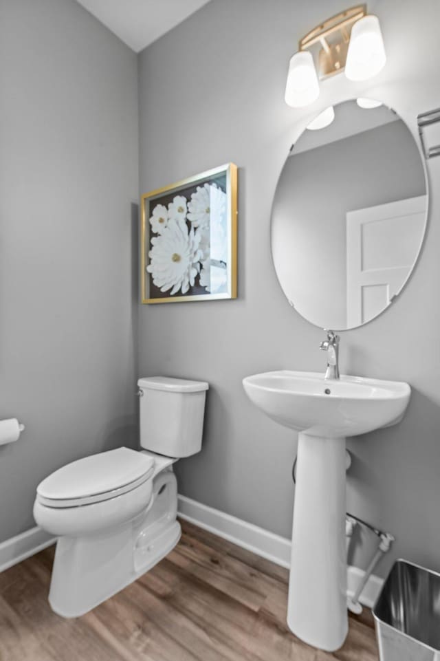 9842 51st St NE, Saint Michael, MN 55376 - bathroom with toilet, baseboards, and wood finished floors