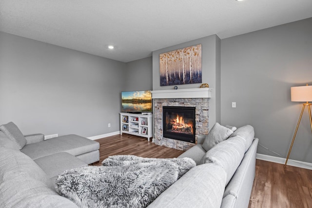 9842 51st St NE, Saint Michael, MN 55376 - living room with baseboards, wood finished floors, a stone fireplace, and recessed lighting