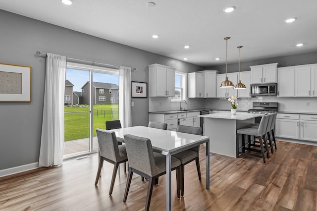 9842 51st St NE, Saint Michael, MN 55376 - dining room with plenty of natural light, dark wood finished floors, recessed lighting, and baseboards