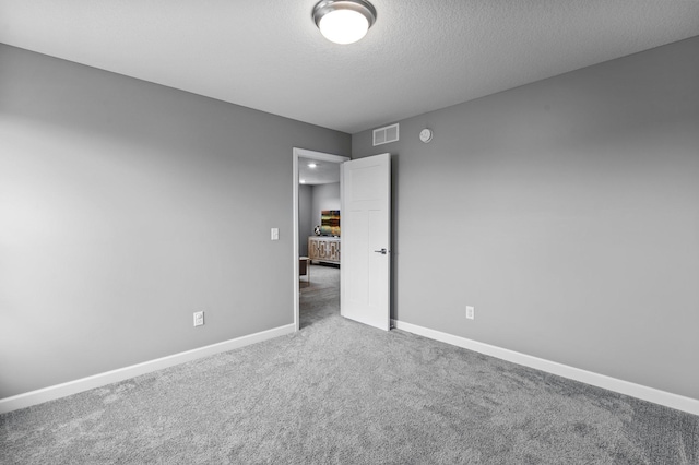 9842 51st St NE, Saint Michael, MN 55376 - unfurnished room featuring carpet flooring, baseboards, and a textured ceiling