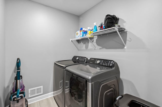 9842 51st St NE, Saint Michael, MN 55376 - laundry area featuring washing machine and dryer, wood finished floors, and baseboards