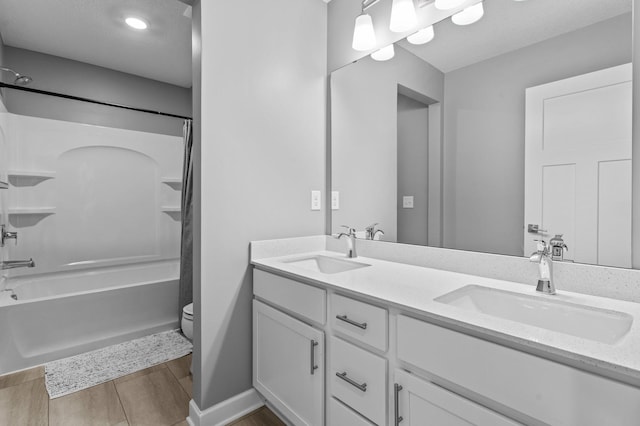 9842 51st St NE, Saint Michael, MN 55376 - bathroom with toilet, double vanity, shower / bath combination, wood finished floors, and baseboards