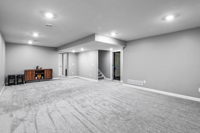 9842 51st St NE, Saint Michael, MN 55376 - finished below grade area with stairway, carpet floors, a textured ceiling, baseboards, and recessed lighting