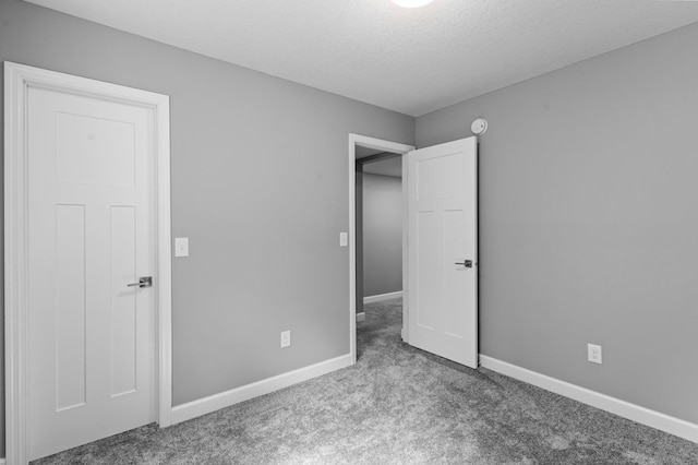 9842 51st St NE, Saint Michael, MN 55376 - unfurnished bedroom with carpet flooring, baseboards, and a textured ceiling