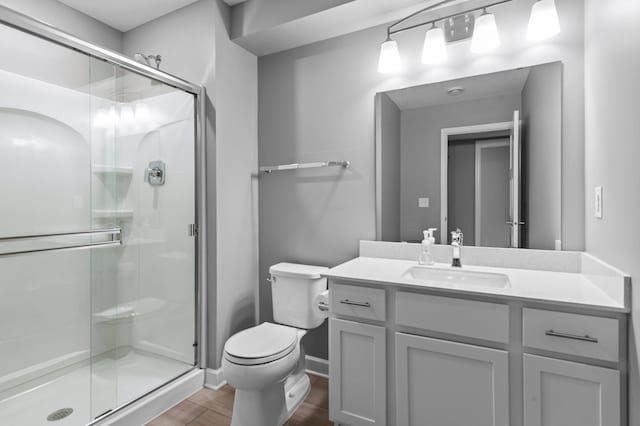 9842 51st St NE, Saint Michael, MN 55376 - bathroom featuring toilet, vanity, wood finished floors, a shower stall, and baseboards