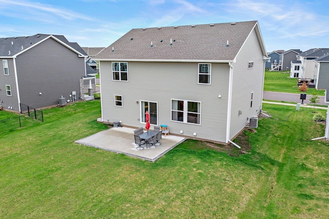 9842 51st St NE, Saint Michael, MN 55376 - back of house featuring a patio area, a yard, central AC, and a residential view
