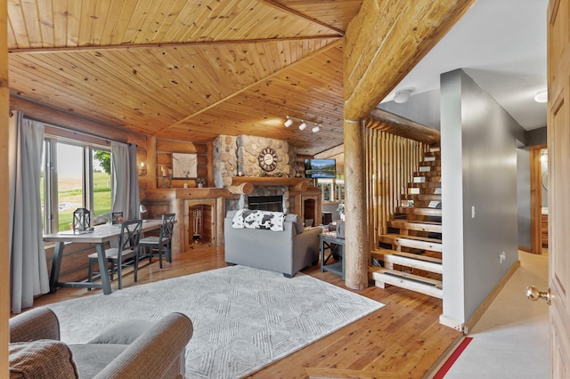 22165 Harlow Ave, Helena Twp, MN 55352 - living area with wood ceiling, stairway, rustic walls, a fireplace, and wood finished floors