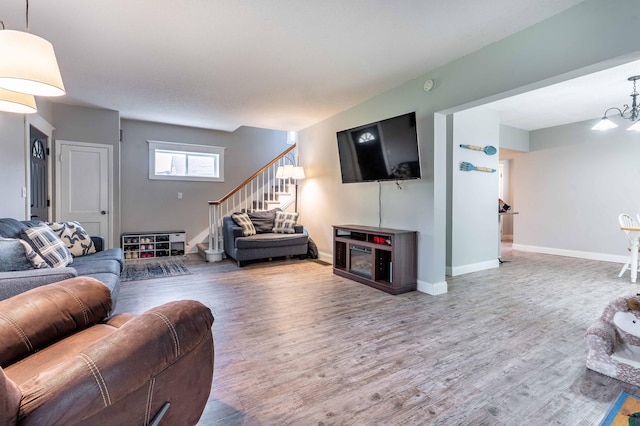 113 7th Ave SE, Elbow Lake, MN 56531 - living area with stairway, wood finished floors, baseboards, and a chandelier