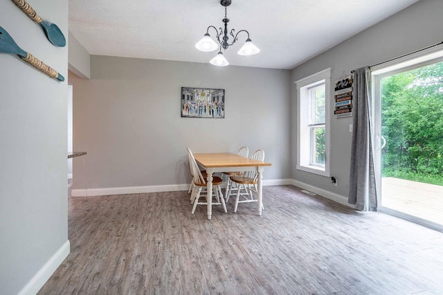 113 7th Ave SE, Elbow Lake, MN 56531 - dining room featuring wood finished floors, baseboards, and a chandelier