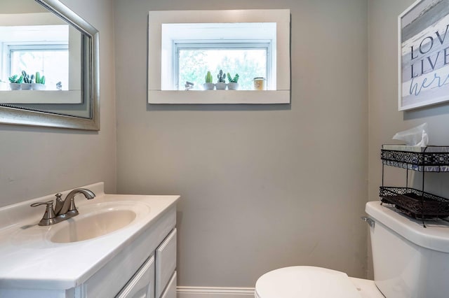 113 7th Ave SE, Elbow Lake, MN 56531 - bathroom with toilet, vanity, healthy amount of natural light, and baseboards