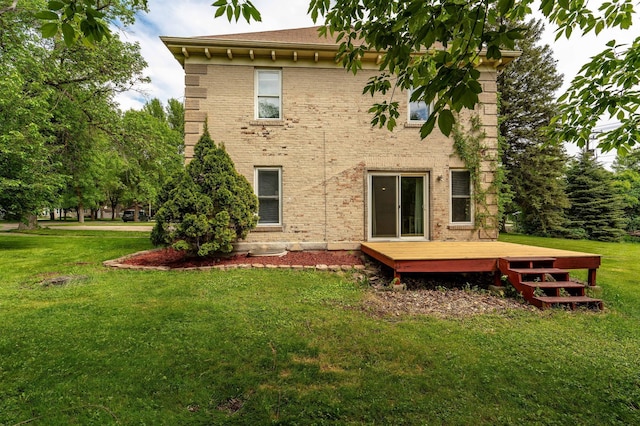 113 7th Ave SE, Elbow Lake, MN 56531 - rear view of house featuring a wooden deck, a lawn, and brick siding
