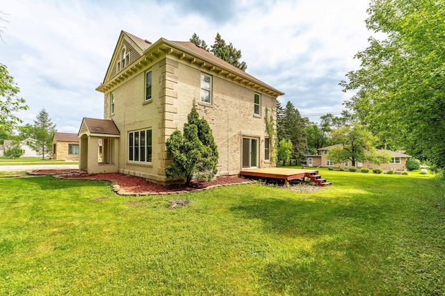 113 7th Ave SE, Elbow Lake, MN 56531 - rear view of house featuring a wooden deck, a lawn, and brick siding