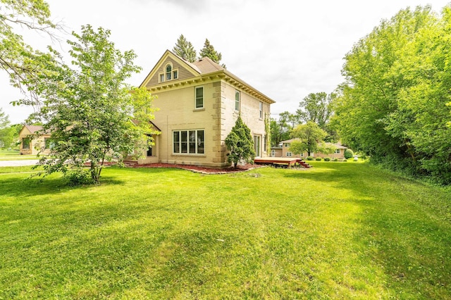 113 7th Ave SE, Elbow Lake, MN 56531 - rear view of property featuring a lawn and a wooden deck