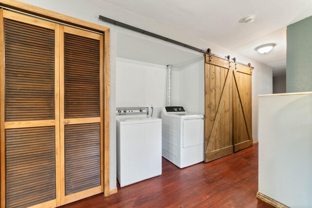 185 Wagon Rd, Esko, MN 55733 - laundry room with washer and clothes dryer, a barn door, and dark wood finished floors