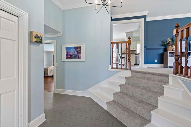 75 Oregon Ave S, Golden Valley, MN 55426 - staircase featuring baseboards, tile patterned flooring, crown molding, and a chandelier