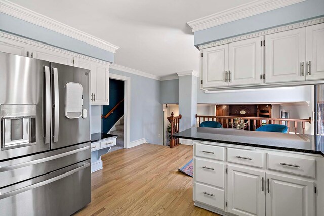 75 Oregon Ave S, Golden Valley, MN 55426 - kitchen featuring stainless steel fridge with ice dispenser, white cabinetry, light wood-style flooring, baseboards, and ornamental molding
