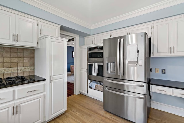 75 Oregon Ave S, Golden Valley, MN 55426 - kitchen featuring appliances with stainless steel finishes, white cabinets, dark countertops, light wood-style flooring, and ornamental molding