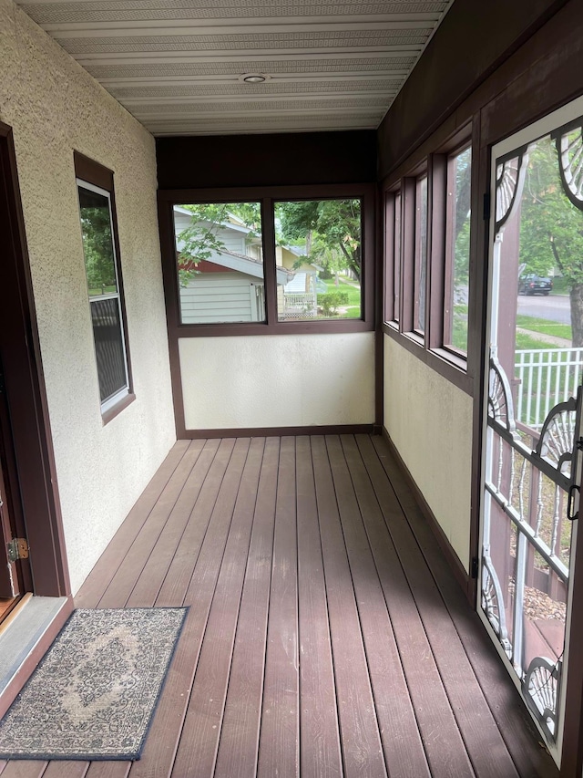 103 31st Ave N, Saint Cloud, MN 56303 - unfurnished sunroom with a textured wall, plenty of natural light, and wood-type flooring