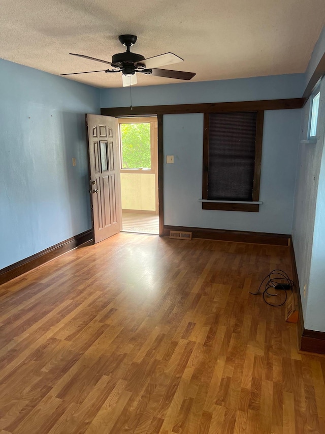 103 31st Ave N, Saint Cloud, MN 56303 - spare room with baseboards, a ceiling fan, wood finished floors, and a textured ceiling