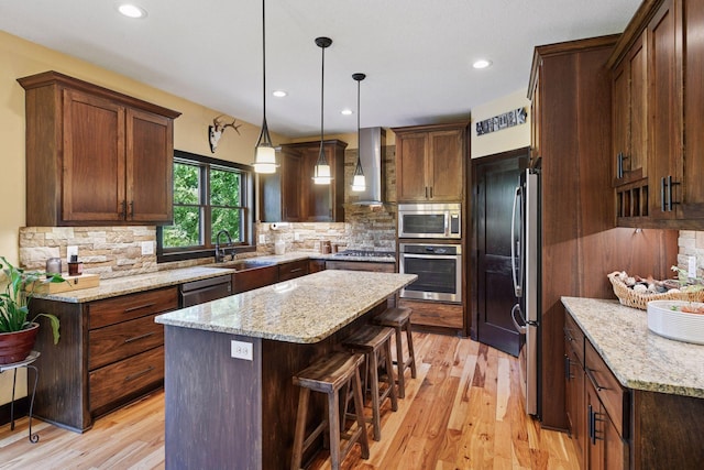 227 Maple Ln, Jordan, MN 55352 - kitchen featuring stainless steel appliances, wall chimney range hood, a center island, a sink, and decorative backsplash