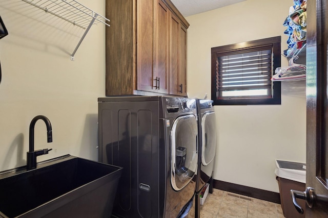 227 Maple Ln, Jordan, MN 55352 - washroom featuring cabinet space, washer and clothes dryer, and baseboards